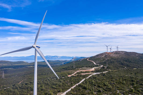 istock Wind turbines, renewable energy on a green hill. Wind farm 1301058288
