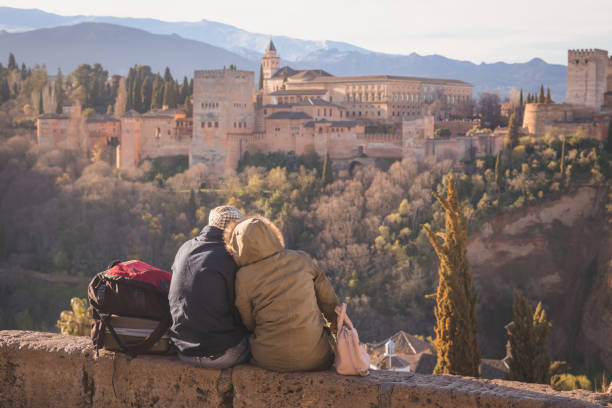 Romantic view of the Alhambra. Granada, Spain A couple enjoy a romantic view at sunrise golden of the iconic Alhambra from Mirador de San Nicolas in old town of Granada, Andalusia, Spain. granada stock pictures, royalty-free photos & images