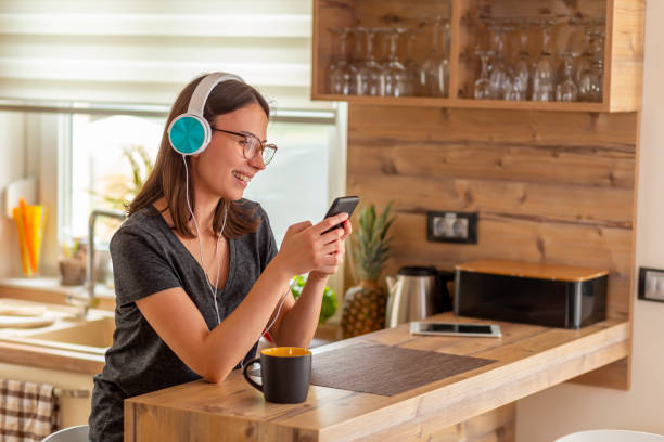 istock Woman wearing headset and using smart phone 1301058648