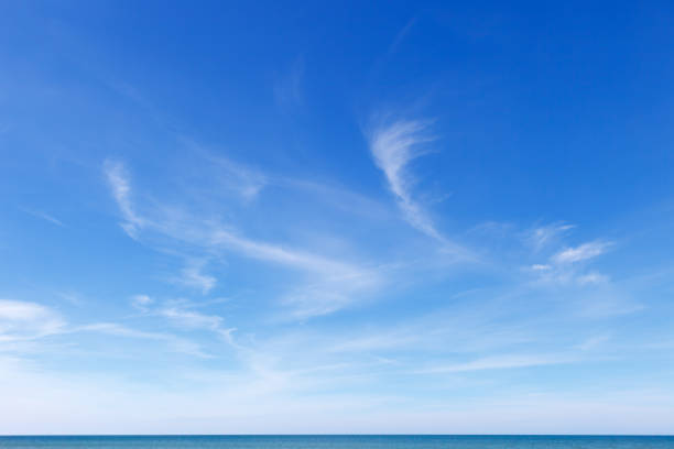 beau ciel bleu au-dessus de la mer avec les nuages translucides, blancs, de cirrus - day sunlight sky sea photos et images de collection