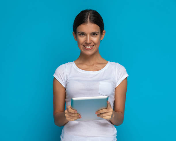 istock casual woman holding a tablet in her hands 1301059336