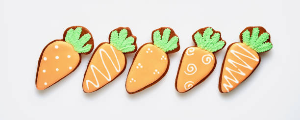 Easter symbol four carrots gingerbread isolated on white. Banner. Top view.