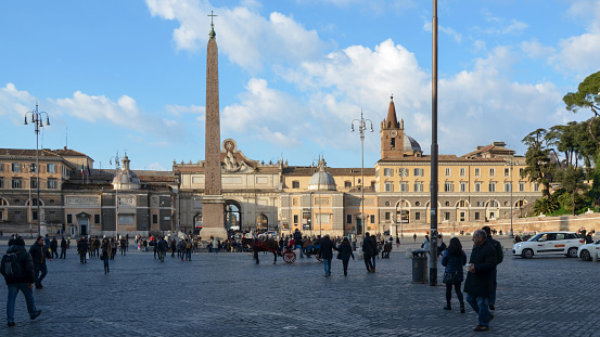 Italy, Rome - February 14, 2019 - Piazza del Popolo is a town square in the historical center of Rome, Italy. One of the most striking sights on this square is the 36-metre-high Egyptian Obelisk. Dating back to 1300 BC, the obelisk originally came from the Temple of the Sun at Heliopolis, was then brought to Rome by Augustus and subsequently stood at the Circus Maximus. The obelisk was restored in 1589 and brought to this place by Pope Sixtus V.