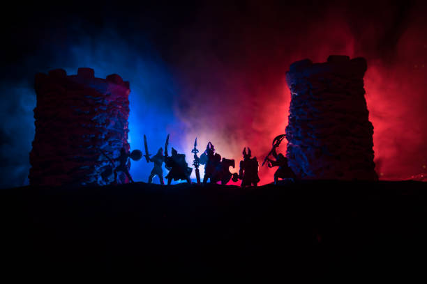 istock Medieval battle scene. Silhouettes of figures as separate objects, fight between warriors at night. Creative artwork decoration. Foggy background. 1301060177