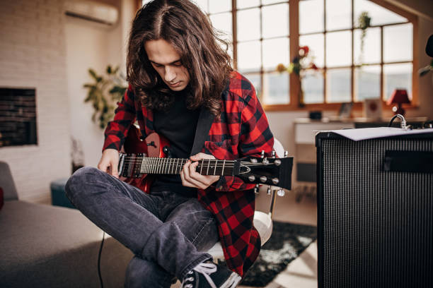istock Male guitarist playing electric guitar 1301060952