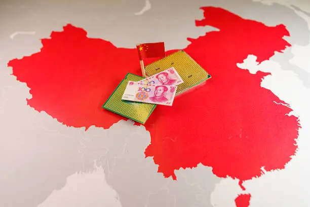 Photo of CPU and yuan bills over a Chinese map, symbolizing the Digital Yuan.