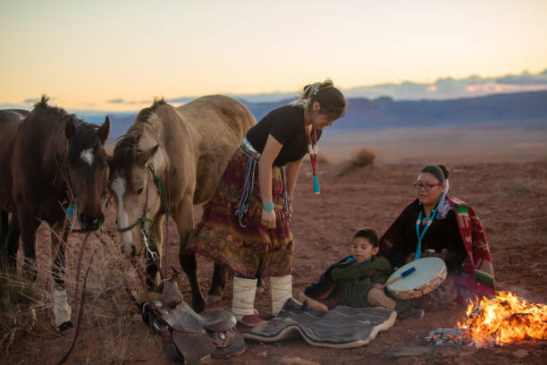 istock Navajo siblings warming up around campfire at sunset 1301062420