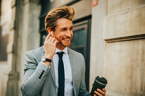 Businessman using bluetooth earphones