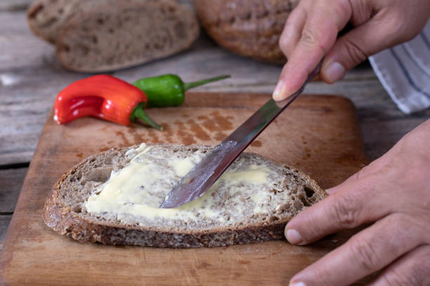 istock butter and bread over wooden table 1301064103