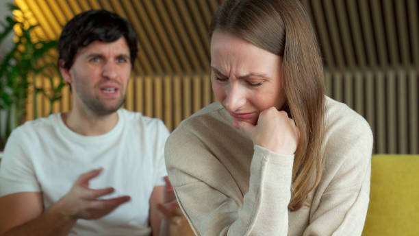 Upset silent wife and furious arguing man talking. Crisis in relationship stock photo