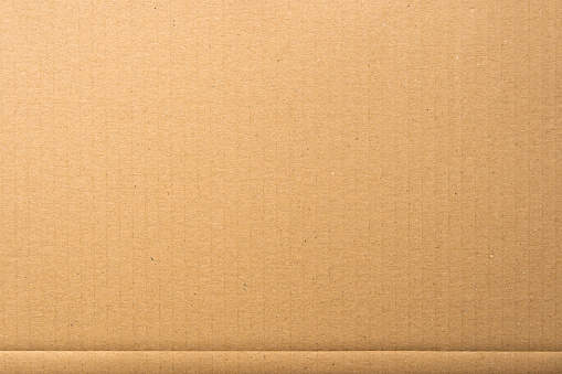 Brown cardboard sheet texture of packaging material. The structure of a carton surface can be used as a background.
