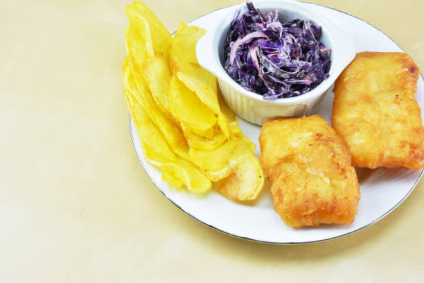 Cod fish , french fries and  red cabbage salad with mayonnaise