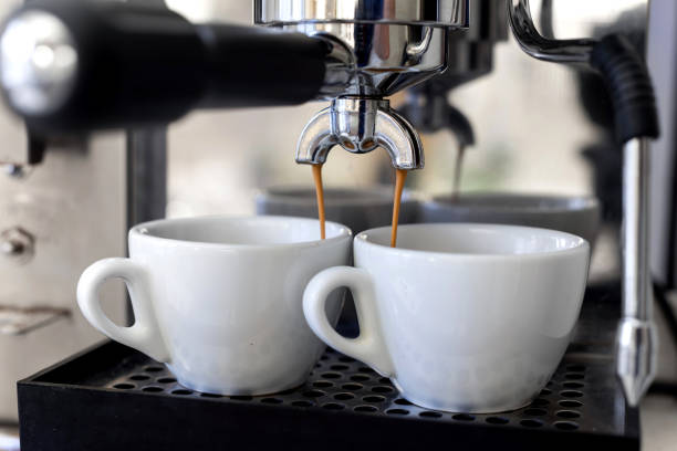 istock Making espresso coffee in white cups in the coffee maker, shallow depth of field. 1301069195