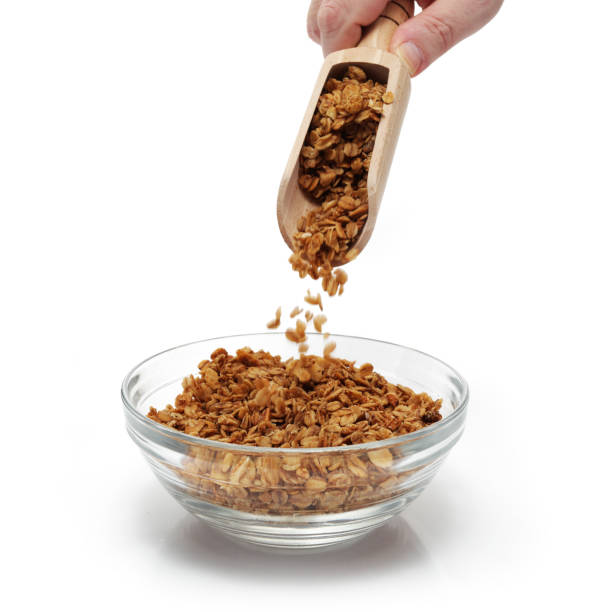 istock Granola being emptied from a scoop into a breakfast bowl 1301069345