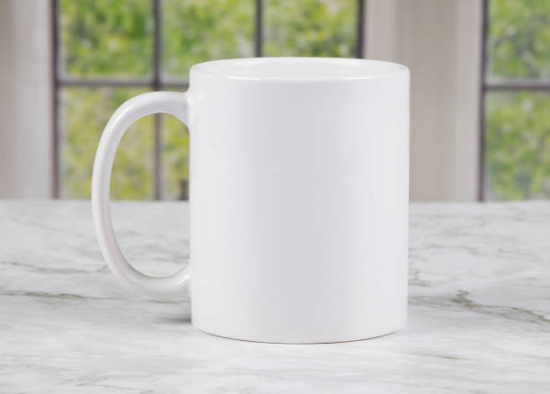 istock White coffee mug with copy space on marble kitchen surface with windows in background 1301069361