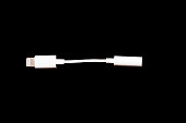 Top view and close up photo of a white lightning to 3.5mm headphone jack audio adapter cable for iphone on work desk from home.