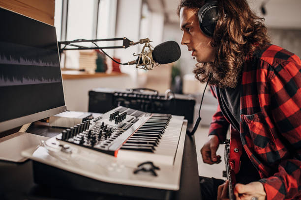 istock Male artist making music in recording studio 1301069844