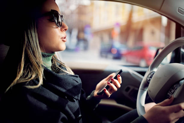 istock Young woman is talking till driving her car 1301071304
