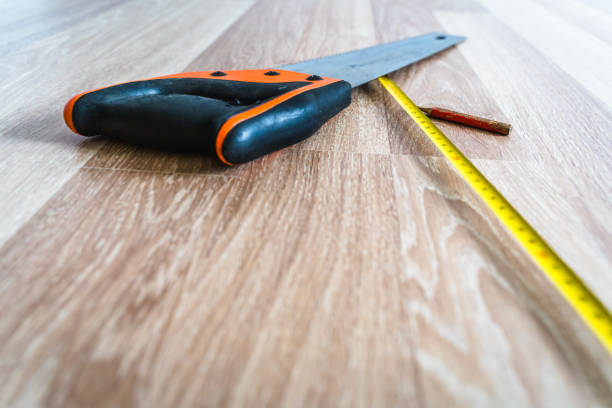 istock Construction Tools Lying on Wooden Floor Boards for Work. Abstract Renovation and Reconstruction Background with Selective Focus and Copy Space 1301072290