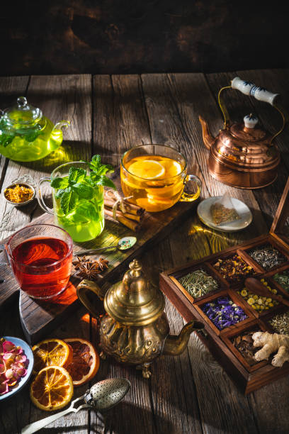 istock Tea and herbal infusion with dried herbs on wooden rustic table board 1301072347