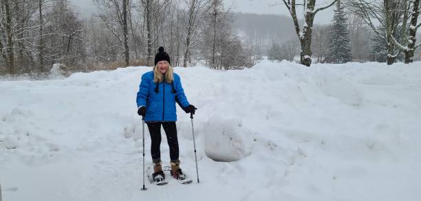 istock Blonde Female Snowshoeing in Deep Snow 1301072379