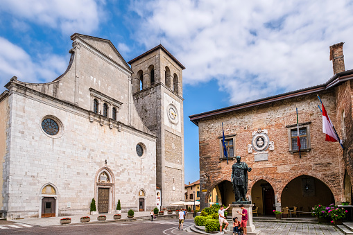 The Cathedral of Santa Maria Assunta, dating to the 15th - 16th century, is the main place of worship of Cividale del Friuli. It is located next to the town hall building and the bronze statue of Julius Caesar, placed in 1935. Tourists resting.