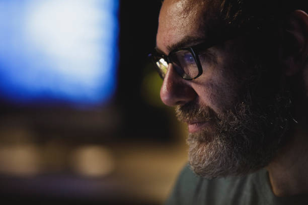 istock Headshot of man working late at the office 1301073792