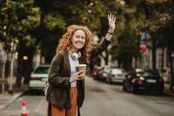 istock A young redhead woman is calling taxi 1301073834