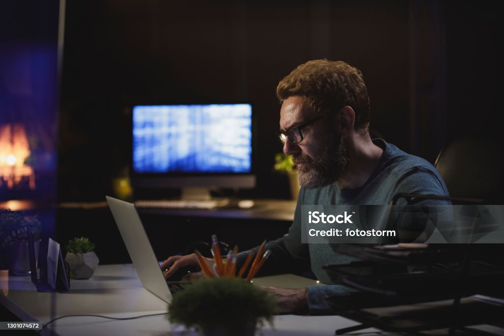 Computer Programmer Staying At The Office Late At Night To Work Stock ...