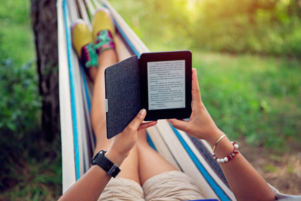 istock Woman is reading e-book in a hammock 1301074658