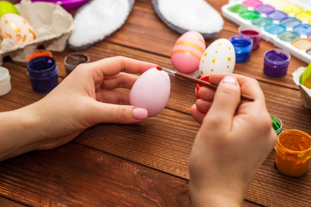 istock Mother and son are painting Easter eggs. Preparing decorations for Easter, creativity with children, traditional symbols. Preparing for Easter. 1301074798