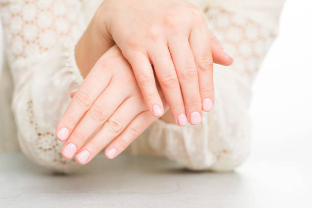 istock Womans hands with beautiful manicure on white background. 1301074820