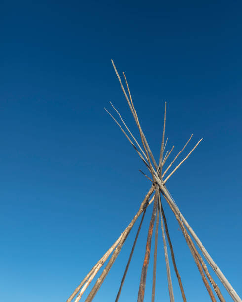 istock A glimpse at the top of a Tipi (Teepee) structure in the making, against a blue sky. 1301074851