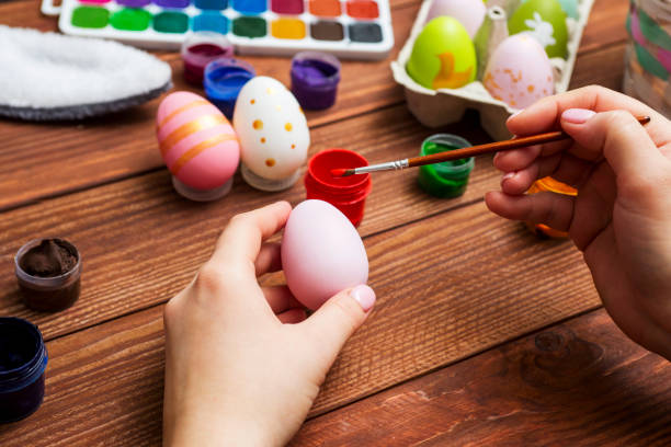 istock Mother and son are painting Easter eggs. Preparing decorations for Easter, creativity with children, traditional symbols. Preparing for Easter. 1301074858