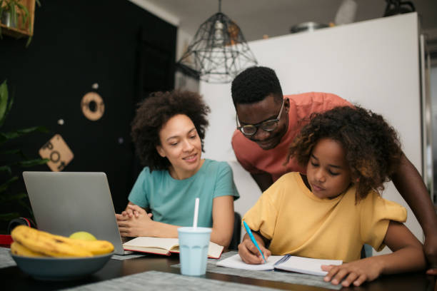 istock Mother and father helping their daughter do her homework 1301075071