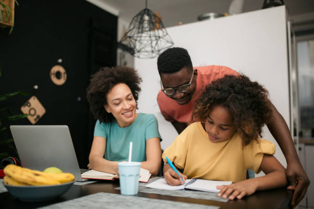 istock Mother and father helping their daughter do her homework 1301075120