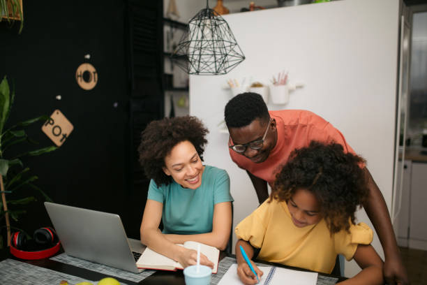 istock Mother and father helping their daughter do her homework 1301075137
