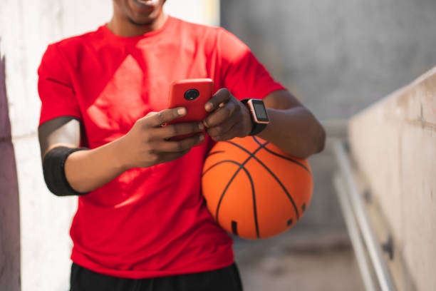 istock Athlete man using his mobile phone outdoors. 1301075745