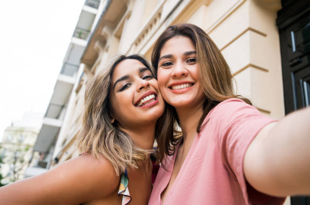 istock Two friends taking a selfie outdoors. 1301075842