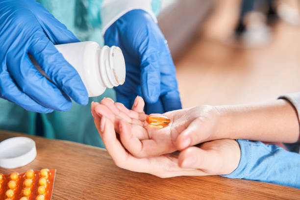 istock Docotr putting pills from the bottle to the hand 1301075926