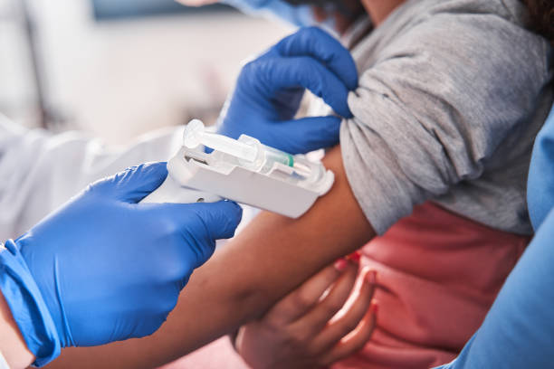 istock Doctor checking elementary age girl's body temperature 1301075976