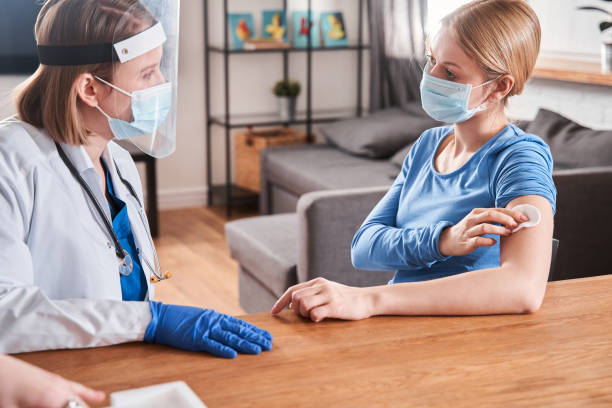 istock Friendly female doctor speaking with patient at home 1301075985