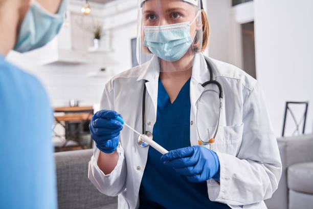 istock Doctor holding test stick for diagnostics coronavirus 1301076027