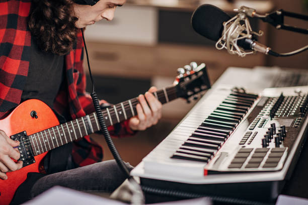istock Male artist making music in recording studio 1301076240