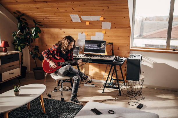 istock Male guitarist playing electric guitar in home studio 1301077336