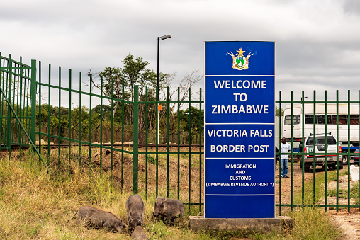Victoria Falls, Zambia - April 9, 2015: View at welcome sign at the border between Zambia and Zimbabwe at Victoria Falls bridge.