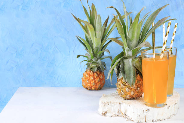 istock Fruit juice and ingredients, summer pineapple drink and mini pineapple on a bright table, detox diet and weight loss concept, healthy and natural food, vitamin C source, selective focus, 1301078561