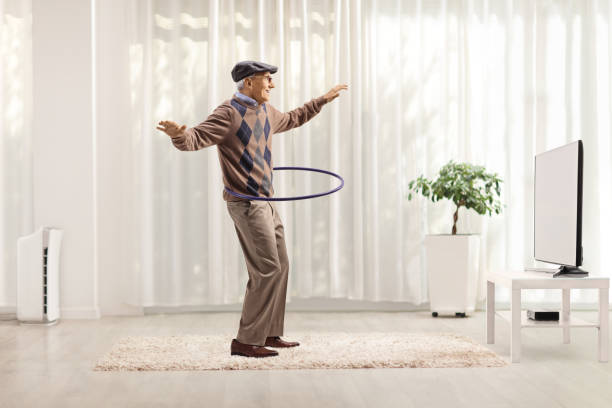 istock Cheerful man having fun and spinning a hula hoop 1301083165