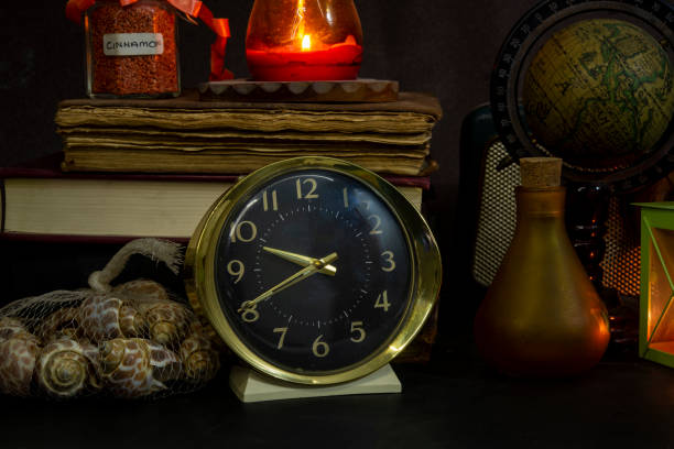 istock Vintage study table view with books and golden clock in front 1301083207