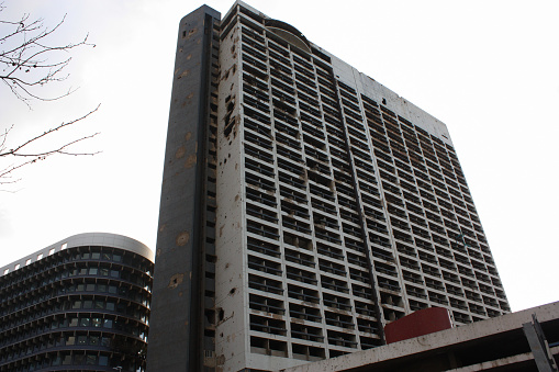Beirut, Lebanon - February 29, 2012: The Holiday Inn Beirut, a former luxury hotel that was heavily damaged during the Lebanese Civil War and has remained in its ruined state since then.